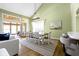 Bright dining area featuring a large table, natural light, and an open connection to the sunroom and living area at 11338 Bayhill Way, Indianapolis, IN 46236