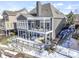 Back exterior of a home with a deck, a balcony, large windows, and a covered patio area at 11338 Bayhill Way, Indianapolis, IN 46236