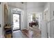Warm and welcoming foyer featuring hardwood floors, a modern chandelier, and a glimpse into the adjacent office at 11338 Bayhill Way, Indianapolis, IN 46236