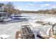 Scenic view of a frozen lake showcasing boat docks and neighboring waterfront properties in winter at 11338 Bayhill Way, Indianapolis, IN 46236