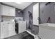 Laundry room with white cabinets, washer and dryer, a utility sink, and a vacuum at 11338 Bayhill Way, Indianapolis, IN 46236