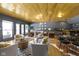 Cozy living room featuring stylish decor, wood ceiling, a fireplace, and a bar at 11338 Bayhill Way, Indianapolis, IN 46236