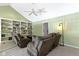 Cozy living room boasting built-in shelves, green walls, and comfortable seating at 11338 Bayhill Way, Indianapolis, IN 46236