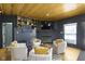 Cozy living room featuring stylish decor, wood ceiling, a fireplace, and a bar at 11338 Bayhill Way, Indianapolis, IN 46236