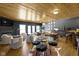 Cozy living room featuring stylish decor, wood ceiling, a fireplace, and a bar at 11338 Bayhill Way, Indianapolis, IN 46236