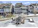 Two-story gray home on a frozen lake, offering a private dock and water access, with an upper deck at 11338 Bayhill Way, Indianapolis, IN 46236