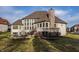 Expansive backyard featuring a stone fireplace with seating area, deck and a trampoline at 11573 Bent Tree Ct, Zionsville, IN 46077