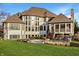 Large backyard featuring a stone patio and seating area with an outdoor fireplace at 11573 Bent Tree Ct, Zionsville, IN 46077