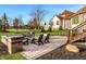Inviting backyard patio area with a stone fire pit and ample seating, perfect for outdoor gatherings at 11573 Bent Tree Ct, Zionsville, IN 46077