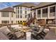 Backyard stone patio with an outdoor fireplace and ample seating for entertaining at 11573 Bent Tree Ct, Zionsville, IN 46077