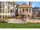 Outdoor stone patio with fireplace, seating and steps leading to an outdoor deck at 11573 Bent Tree Ct, Zionsville, IN 46077