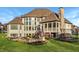 Expansive backyard featuring a stone fireplace with seating area, deck and a trampoline at 11573 Bent Tree Ct, Zionsville, IN 46077
