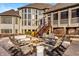 Backyard stone patio with an outdoor fireplace and ample seating for entertaining at 11573 Bent Tree Ct, Zionsville, IN 46077