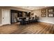 Basement bar with dark cabinetry, granite countertops, and seating for eight at 11573 Bent Tree Ct, Zionsville, IN 46077