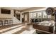Finished basement featuring a shuffleboard table, wet bar, and a dining area with lots of light from the large windows at 11573 Bent Tree Ct, Zionsville, IN 46077