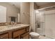 Bathroom featuring granite countertops, a glass-enclosed shower, and ample cabinet space at 11573 Bent Tree Ct, Zionsville, IN 46077