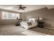 Cozy bedroom with neutral decor, ceiling fan, large windows and a treadmill at 11573 Bent Tree Ct, Zionsville, IN 46077