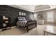 Well-lit bedroom featuring a comfortable bed, complemented by a modern dresser and stylish decor at 11573 Bent Tree Ct, Zionsville, IN 46077