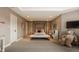 Spacious bedroom with a modern four-poster bed and comfortable seating area at 11573 Bent Tree Ct, Zionsville, IN 46077