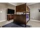 Cozy bedroom showcasing a wooden bunk bed and dresser, complemented by carpet flooring and soft lighting at 11573 Bent Tree Ct, Zionsville, IN 46077