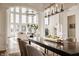Dining area next to the living room featuring stylish lighting, a large table, and views of the outdoor scenery at 11573 Bent Tree Ct, Zionsville, IN 46077