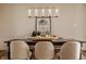Close-up of a dining table with decorative elements and comfortable seating under a modern chandelier at 11573 Bent Tree Ct, Zionsville, IN 46077