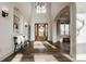 Bright foyer featuring hardwood floors, large windows, statement lighting and elegant staircase at 11573 Bent Tree Ct, Zionsville, IN 46077