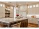 Bright kitchen with an island, pendant lights, and white custom cabinets at 11573 Bent Tree Ct, Zionsville, IN 46077