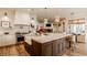 Spacious kitchen with wooden floors, an island with seating, and stainless steel appliances at 11573 Bent Tree Ct, Zionsville, IN 46077