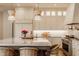 Modern kitchen with a large island, stylish seating, custom cabinets, and stainless steel appliances at 11573 Bent Tree Ct, Zionsville, IN 46077