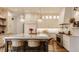 Bright, modern kitchen with a large island, custom cabinets, pendant lights, and stainless steel appliances at 11573 Bent Tree Ct, Zionsville, IN 46077