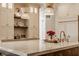 Bright kitchen with an island, pendant lights, and white custom cabinets at 11573 Bent Tree Ct, Zionsville, IN 46077