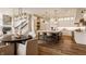 Open kitchen and dining area featuring an island with seating, custom cabinets, and modern lighting at 11573 Bent Tree Ct, Zionsville, IN 46077