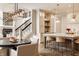 Elegant kitchen and dining area featuring an island with seating, custom cabinets, and modern lighting fixtures at 11573 Bent Tree Ct, Zionsville, IN 46077