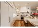 Elegant kitchen featuring white cabinets, a marble backsplash, and stainless steel appliances at 11573 Bent Tree Ct, Zionsville, IN 46077