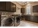 Functional laundry room with stainless steel appliances, countertop space, and ample storage at 11573 Bent Tree Ct, Zionsville, IN 46077