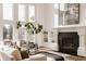Bright living room showcases fireplace, built-in shelves, and large windows with scenic views at 11573 Bent Tree Ct, Zionsville, IN 46077