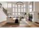 Bright living room with soaring windows, fireplace and modern decor at 11573 Bent Tree Ct, Zionsville, IN 46077