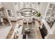 Aerial view of an elegant living room featuring a stunning chandelier and views of the surrounding greenery at 11573 Bent Tree Ct, Zionsville, IN 46077