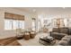 Open-concept living room with hardwood floors, comfortable seating, and a view into the kitchen at 11573 Bent Tree Ct, Zionsville, IN 46077