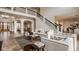 Spacious living room with high ceilings, a grand staircase, and elegant furnishings, with warm wood floors at 11573 Bent Tree Ct, Zionsville, IN 46077