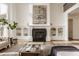 Bright living room with fireplace, built-in shelves, and hardwood floors at 11573 Bent Tree Ct, Zionsville, IN 46077