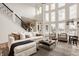 Bright, open living room featuring a staircase, soaring windows, and comfortable seating arrangement at 11573 Bent Tree Ct, Zionsville, IN 46077