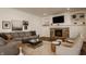 Inviting living room featuring a stone fireplace, built-in shelves, and comfortable seating at 11573 Bent Tree Ct, Zionsville, IN 46077