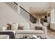 Comfortable living room featuring a staircase, plush sofa, and views of the open-concept layout at 11573 Bent Tree Ct, Zionsville, IN 46077