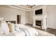 Main bedroom featuring tray ceiling, fireplace, and large windows that provide abundant natural light at 11573 Bent Tree Ct, Zionsville, IN 46077