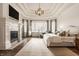 Luxurious main bedroom with fireplace, tray ceilings, and large windows with designer curtains at 11573 Bent Tree Ct, Zionsville, IN 46077