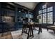 Elegant office with custom built-ins, a large window, and a stylish trestle desk at 11573 Bent Tree Ct, Zionsville, IN 46077