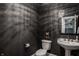 Stylish powder room with a pedestal sink, decorative wallpaper, and modern fixtures at 11573 Bent Tree Ct, Zionsville, IN 46077