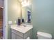 Well-lit half bathroom with a modern vanity, stylish mirror, and neutral tones for a clean, fresh look at 1208 Chapman Dr, Westfield, IN 46074